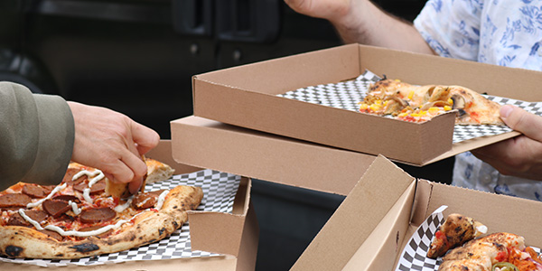 Close up of customers eating pizzas